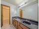A bathroom featuring dual sinks, a large mirror, and a tub/shower combination at 3835 Shawnee Sw Run, Lilburn, GA 30047