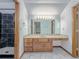 Bathroom featuring a marble countertop, a shower stall, and tile floors at 3835 Shawnee Sw Run, Lilburn, GA 30047
