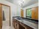 A bathroom featuring a single sink, a large mirror, and a tub/shower combination at 3835 Shawnee Sw Run, Lilburn, GA 30047