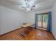 Bedroom featuring a ceiling fan and a large window with views of the trees at 3835 Shawnee Sw Run, Lilburn, GA 30047
