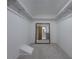 Spacious walk-in closet featuring carpet, open shelving and a large mirror at 3835 Shawnee Sw Run, Lilburn, GA 30047