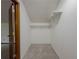 Walk-in closet with carpet, a built-in shelf, and a hanging rack at 3835 Shawnee Sw Run, Lilburn, GA 30047