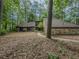 Charming home featuring stone accents and wooded surroundings at 3835 Shawnee Sw Run, Lilburn, GA 30047