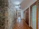 Hallway featuring stone wall and parquet flooring at 3835 Shawnee Sw Run, Lilburn, GA 30047