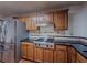 Updated kitchen with stainless steel fridge, gas range cooktop and wood cabinets at 3835 Shawnee Sw Run, Lilburn, GA 30047