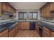 Updated kitchen features wood cabinets, a gas cooktop, black appliances, and granite counters at 3835 Shawnee Sw Run, Lilburn, GA 30047