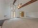 Living room with high vaulted ceilings, exposed beams, and multiple windows for natural light at 3835 Shawnee Sw Run, Lilburn, GA 30047