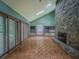 Open living room with stone fireplace, cabinets, and parquet floors at 3835 Shawnee Sw Run, Lilburn, GA 30047