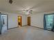 A spacious main bedroom with a ceiling fan and three doorways at 3835 Shawnee Sw Run, Lilburn, GA 30047