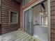 Exterior porch featuring wood flooring and sliding glass door to interior living space at 3835 Shawnee Sw Run, Lilburn, GA 30047