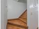 Carpet-free staircase featuring warm-toned wooden steps and white walls at 3835 Shawnee Sw Run, Lilburn, GA 30047