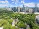 Stunning aerial view showcasing a neighborhood, verdant trees, and the vibrant city skyline beyond at 40 Ivy Chase Ne, Atlanta, GA 30342