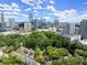 Scenic aerial shot featuring a community nestled among trees, with the modern cityscape in the distance at 40 Ivy Chase Ne, Atlanta, GA 30342