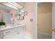 Bright bathroom featuring double sinks, vanity lighting, and access to additional rooms and storage at 40 Ivy Chase Ne, Atlanta, GA 30342