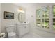 Charming half bathroom with a white vanity, updated lighting and plantation shutters at 40 Ivy Chase Ne, Atlanta, GA 30342