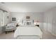 Comfortable bedroom featuring a plush chair, white bedding, natural light from the window, and soft carpet at 40 Ivy Chase Ne, Atlanta, GA 30342