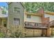 Two-story home featuring a deck above a two-car garage, complemented by mature trees and a well-maintained exterior at 40 Ivy Chase Ne, Atlanta, GA 30342