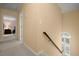 Second floor hallway featuring stairwell with transom window and view to a bedroom at 40 Ivy Chase Ne, Atlanta, GA 30342
