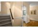 Inviting hallway with staircase, hardwood floors, neutral paint and trim, with open view to a powder room at 40 Ivy Chase Ne, Atlanta, GA 30342