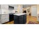Bright kitchen with a center island, stainless steel appliances, white cabinets, and hardwood floors at 40 Ivy Chase Ne, Atlanta, GA 30342
