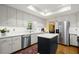 Kitchen with a stainless steel refrigerator, dishwasher, white cabinets, and an island for extra counter space at 40 Ivy Chase Ne, Atlanta, GA 30342