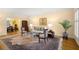 Cozy living room with hardwood floors, neutral walls, fireplace, and adjacent dining area at 40 Ivy Chase Ne, Atlanta, GA 30342