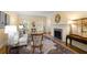 Elegant living room featuring hardwood floors, a fireplace, shutters, and stylish furnishings at 40 Ivy Chase Ne, Atlanta, GA 30342