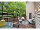 Relaxing outdoor patio with a wooden deck, comfortable seating, and a view of the surrounding trees at 40 Ivy Chase Ne, Atlanta, GA 30342
