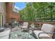 Inviting backyard patio with chairs, a grill, and lush surroundings, perfect for outdoor entertaining at 40 Ivy Chase Ne, Atlanta, GA 30342