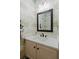 Charming powder room with patterned wallpaper, modern light fixture, and vanity with a dark faucet at 40 Ivy Chase Ne, Atlanta, GA 30342