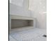 Custom shower features white marble tile, built in niche, and gray honeycomb tile floor at 40 Ivy Chase Ne, Atlanta, GA 30342