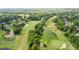 Aerial view of a golf course surrounded by lush greenery and upscale homes at 5950 Meadow Brook Ln, Cumming, GA 30040