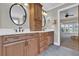 This bathroom features dual sinks, wood cabinets, and granite countertops at 5950 Meadow Brook Ln, Cumming, GA 30040