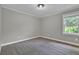This bedroom has a window and neutral colors at 5950 Meadow Brook Ln, Cumming, GA 30040