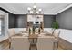 Formal dining room with table set for a meal, chandelier, and wainscoting at 5950 Meadow Brook Ln, Cumming, GA 30040
