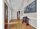 Elegant foyer with hardwood floors, high ceilings, a decorative saddle, and ample natural light at 5950 Meadow Brook Ln, Cumming, GA 30040