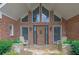 Charming brick home featuring large windows, decorative plants and rocking chairs at 5950 Meadow Brook Ln, Cumming, GA 30040
