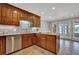 Well-lit kitchen with stainless steel appliances and stone backsplash at 5950 Meadow Brook Ln, Cumming, GA 30040