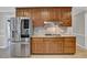 Kitchen featuring stainless steel refrigerator, custom cabinets, and gas cooktop at 5950 Meadow Brook Ln, Cumming, GA 30040
