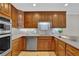 Well-lit kitchen boasts stainless steel appliances, custom cabinets, and neutral countertops at 5950 Meadow Brook Ln, Cumming, GA 30040