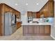 Open kitchen with stainless steel appliances, wooden cabinets, and a kitchen island at 5950 Meadow Brook Ln, Cumming, GA 30040