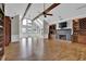 Spacious living room with vaulted ceilings, fireplace, and large windows providing natural light at 5950 Meadow Brook Ln, Cumming, GA 30040