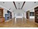 Open living room featuring hardwood floors, exposed beams and a cozy fireplace at 5950 Meadow Brook Ln, Cumming, GA 30040