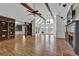 Spacious living room with vaulted ceilings, fireplace, and large windows providing natural light at 5950 Meadow Brook Ln, Cumming, GA 30040