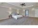 Large main bedroom boasts a tray ceiling, carpet flooring, and neutral paint at 5950 Meadow Brook Ln, Cumming, GA 30040