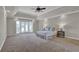 Spacious main bedroom featuring tray ceiling, carpet flooring, and exterior access at 5950 Meadow Brook Ln, Cumming, GA 30040