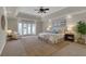Spacious main bedroom with a tray ceiling, ceiling fan, neutral decor and access to outdoor living at 5950 Meadow Brook Ln, Cumming, GA 30040
