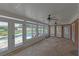 Bright sunroom with stone flooring, ceiling fans, and views of the pool and backyard at 5950 Meadow Brook Ln, Cumming, GA 30040