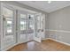 Bright room with tile flooring leads to a sunroom with windows, ceiling fan and views of the outdoor area at 5950 Meadow Brook Ln, Cumming, GA 30040