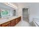 Primary bathroom with dual sinks, a large mirror, and wood cabinets at 1265 Kelly Nelson Dr, Lawrenceville, GA 30043